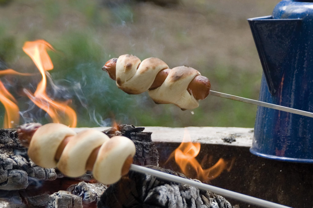 Campfire Twirly Dogs are an exciting new twist to the ol' weenie roast and a great addition to any July 4th celebration.