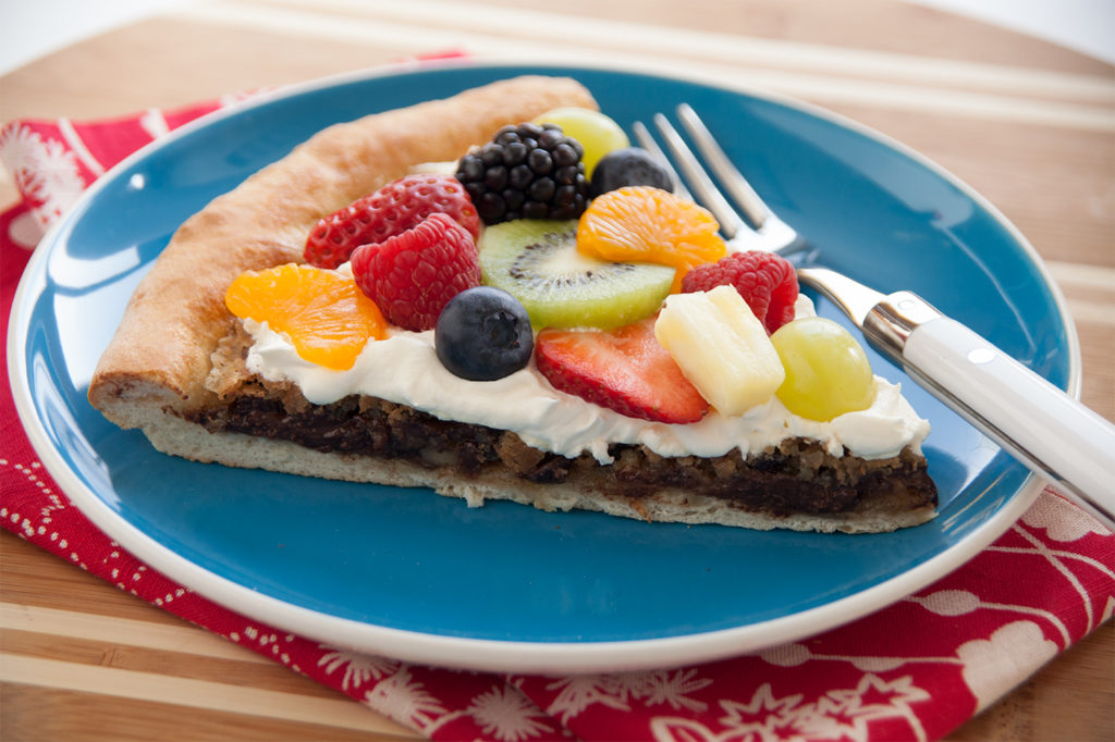 This variation of fruit pizza has chocolate chips as an additional taste delight.