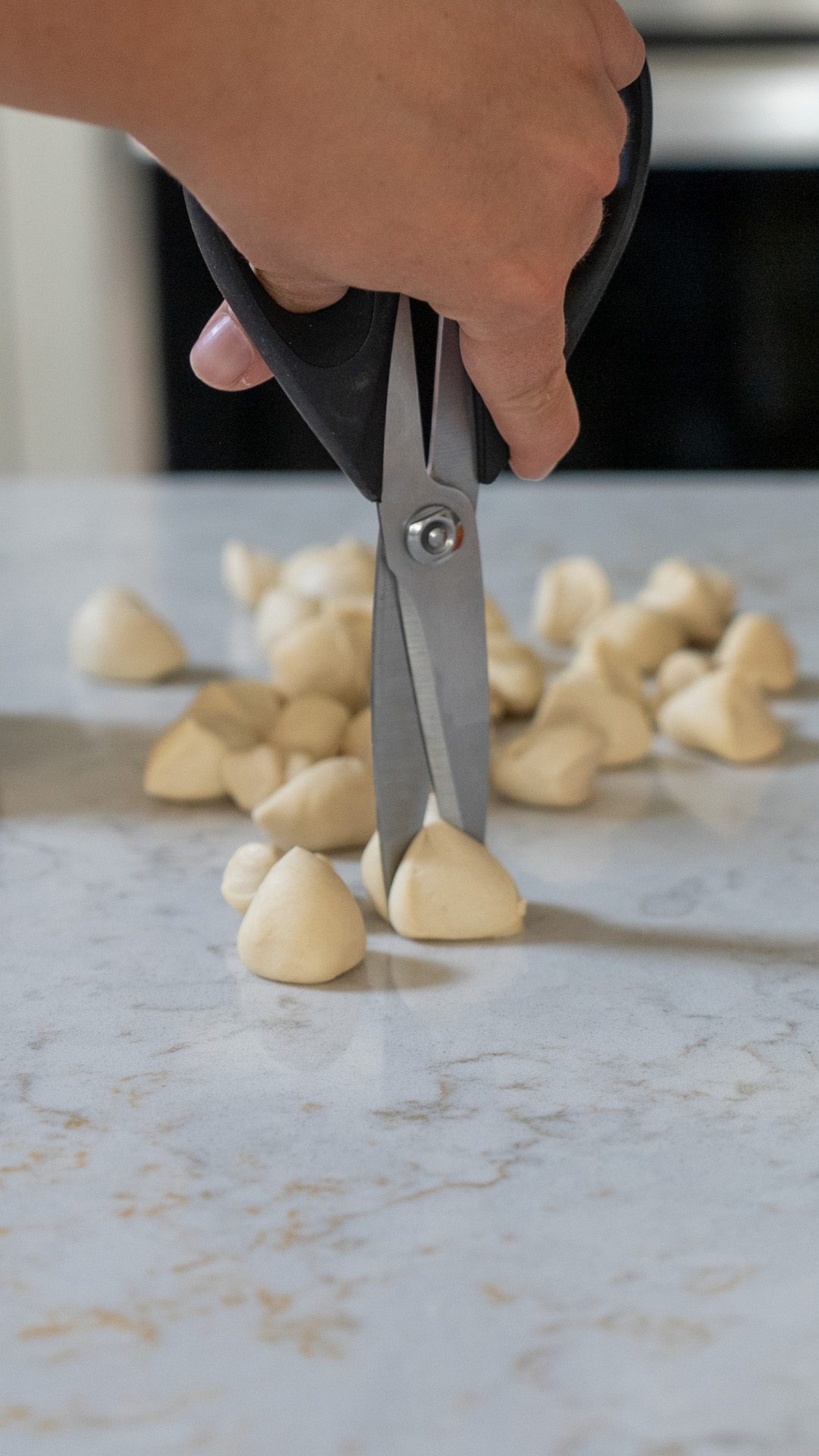 Scissors cutting thawed dough.