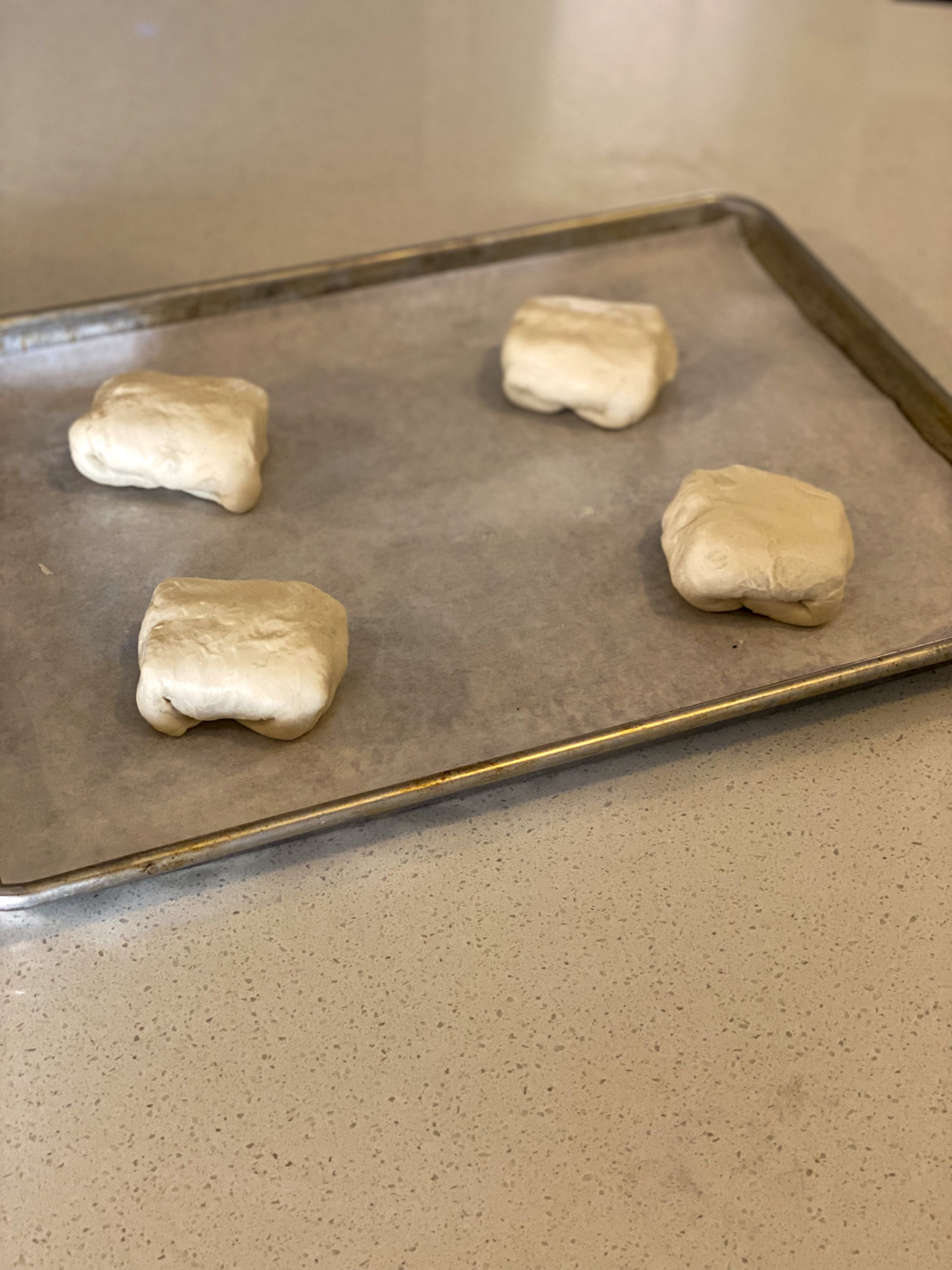 Then fold the over two sides and place seam side down on a sprayed baking sheet.