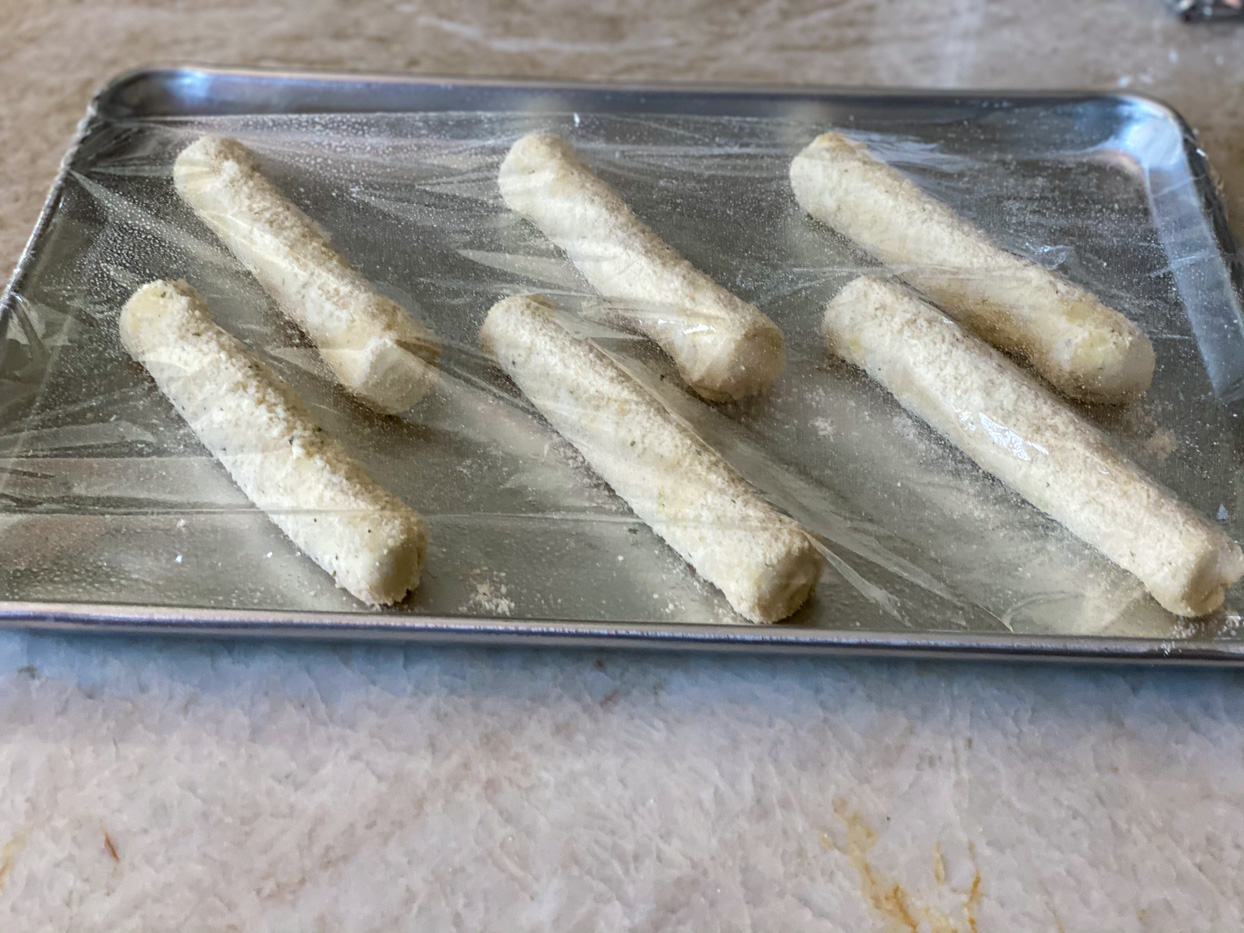 Recipe dough rising under plastic wrap.