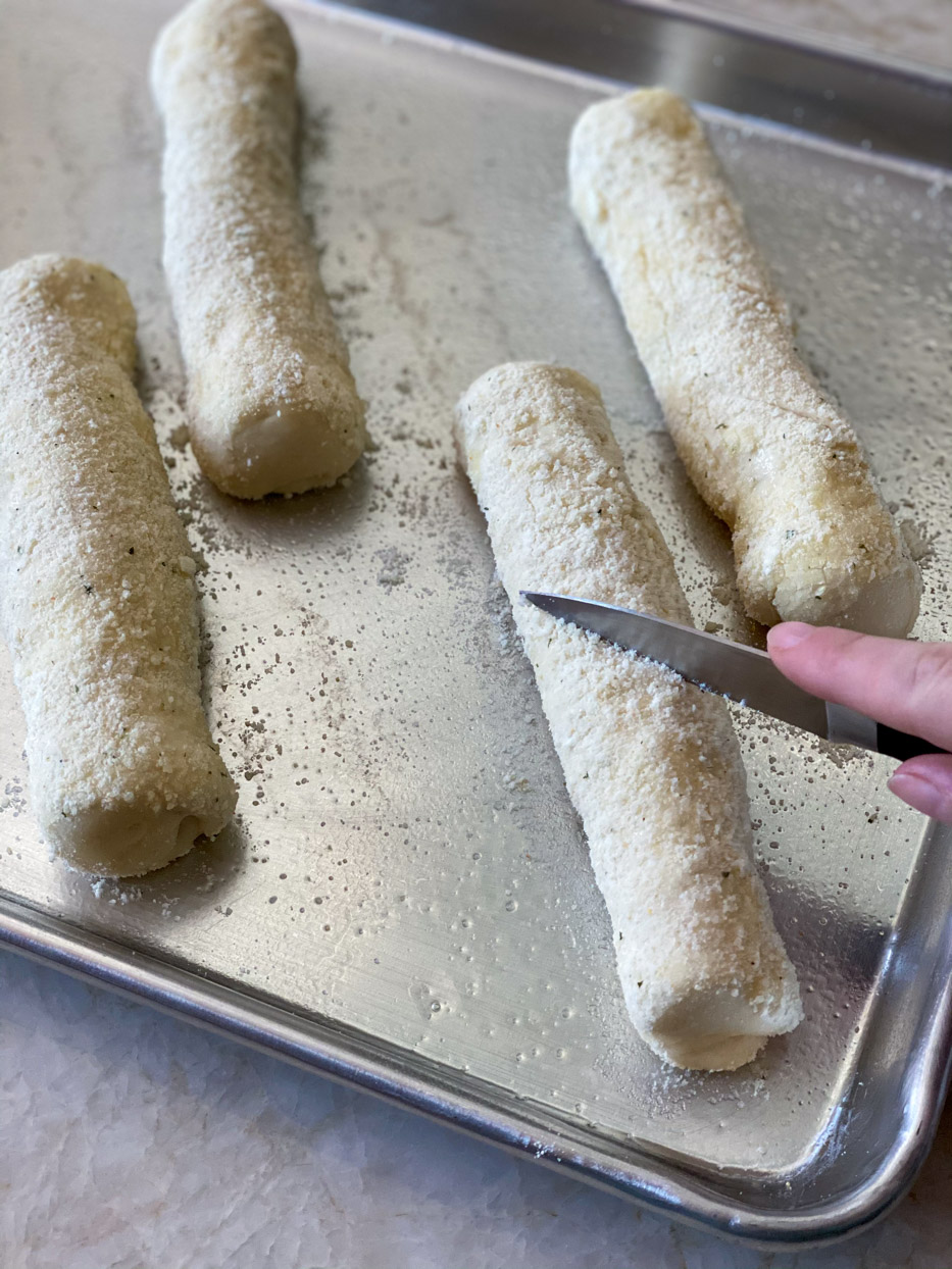 Knife cutting vents in dough.