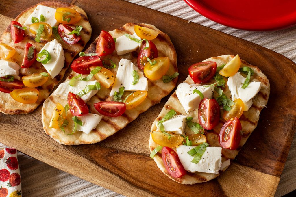 You don’t have to heat up your kitchen to enjoy a delicious summer appetizer with these grilled flatbreads.