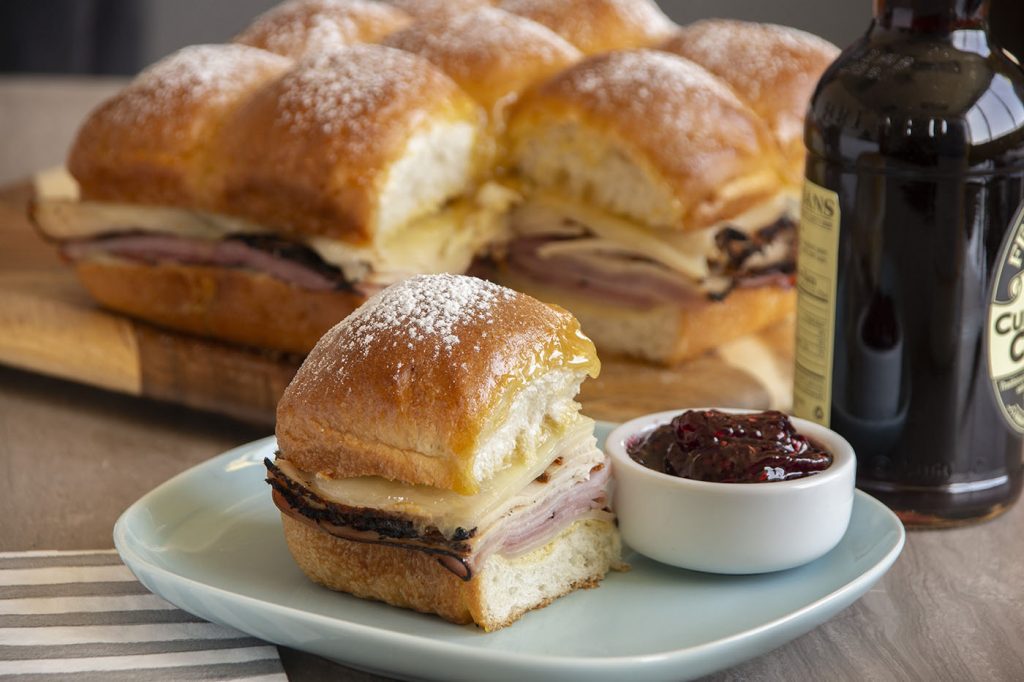Indulge in this savory and sweet Monte Cristo Slider. Similar to a hot ham and cheese but topped with a sweet mustard glaze, dusted with powdered sugar and jam served on the side.