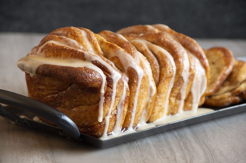 Cozy up on a chilly fall day with this gooey and delectable Pumpkin Spice Pull-apart Loaf with the most delicious Rum Glaze!