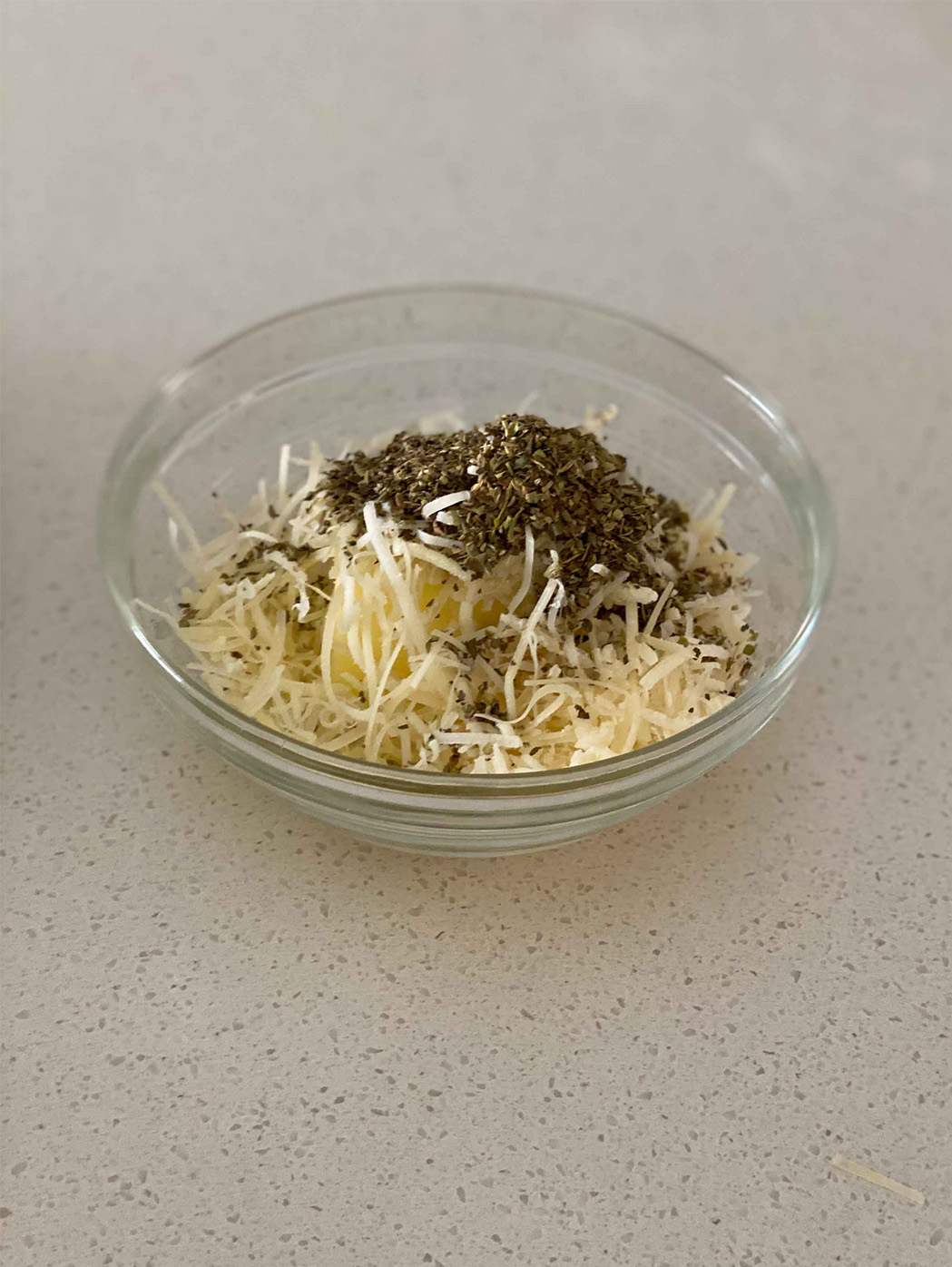 Cheese and herbs in a bowl.