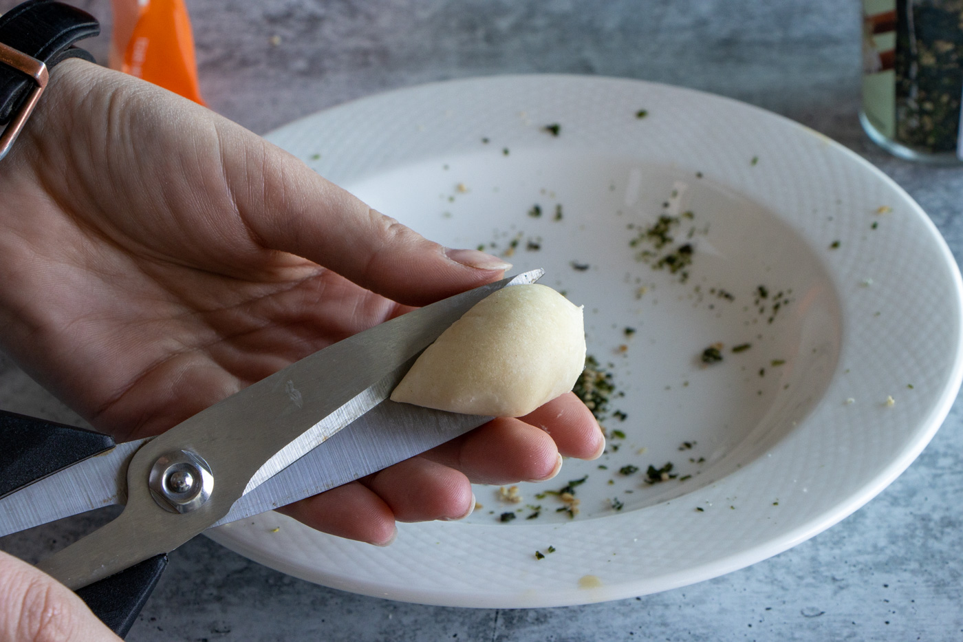 Cutting roll dough in half.