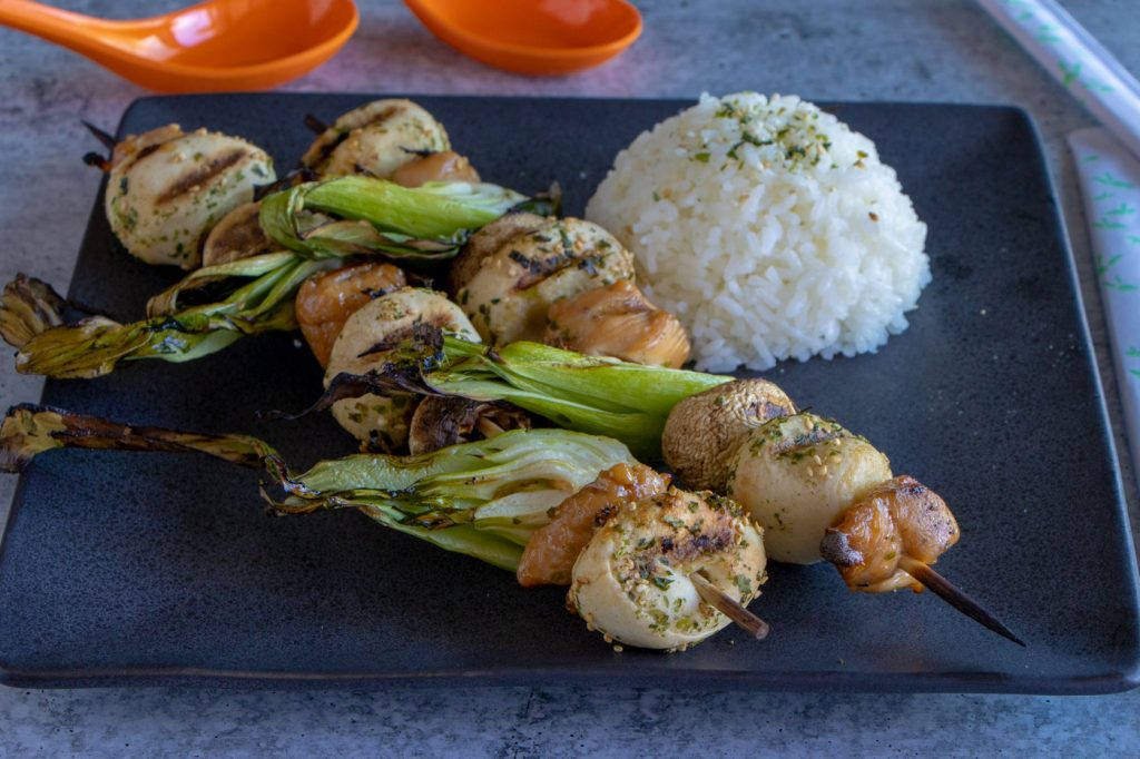 Asian Chicken Skewers on plate with rice.