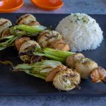 Asian Chicken Skewers on plate with rice.