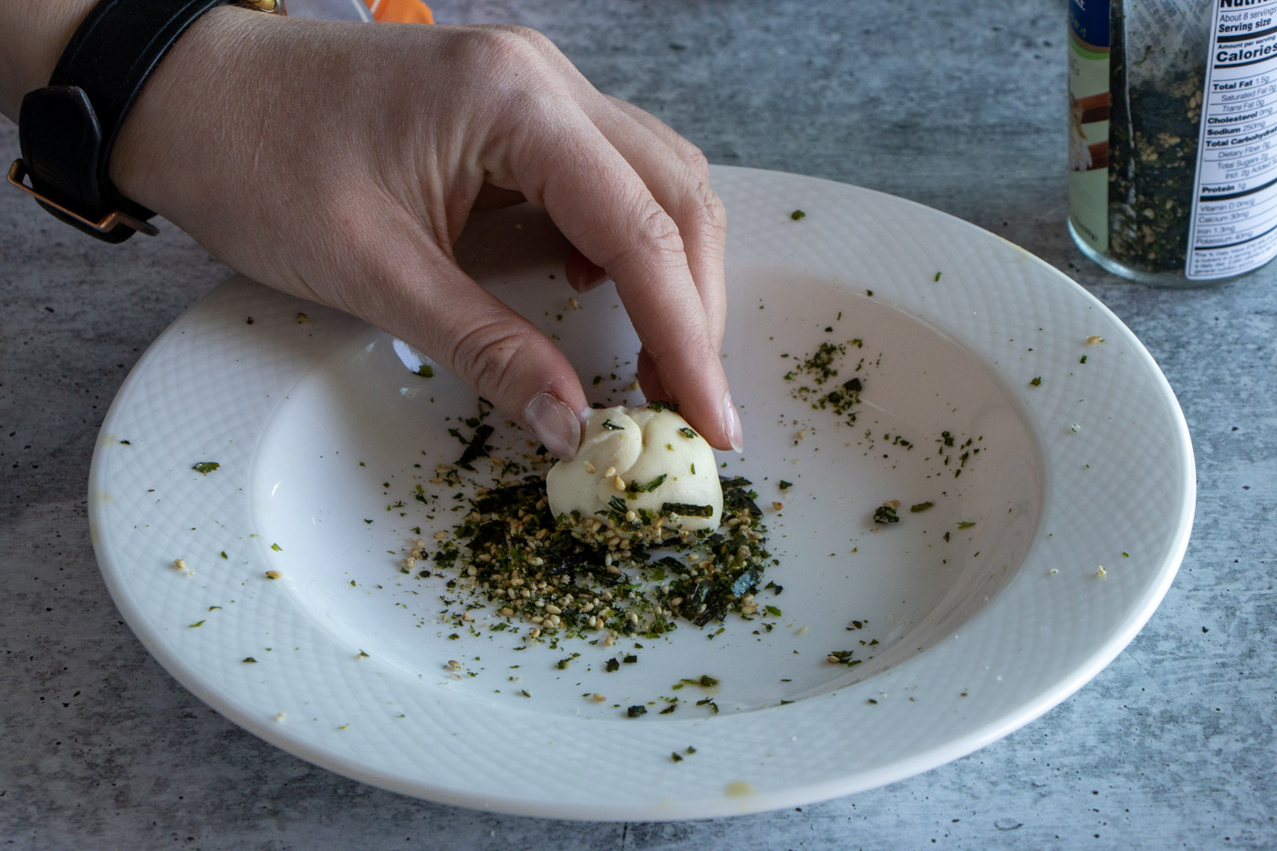 Dough being rolled in furikake.