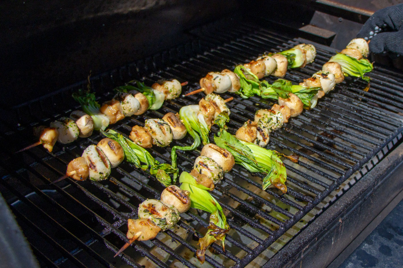 Asian chicken skewers on the grill.
