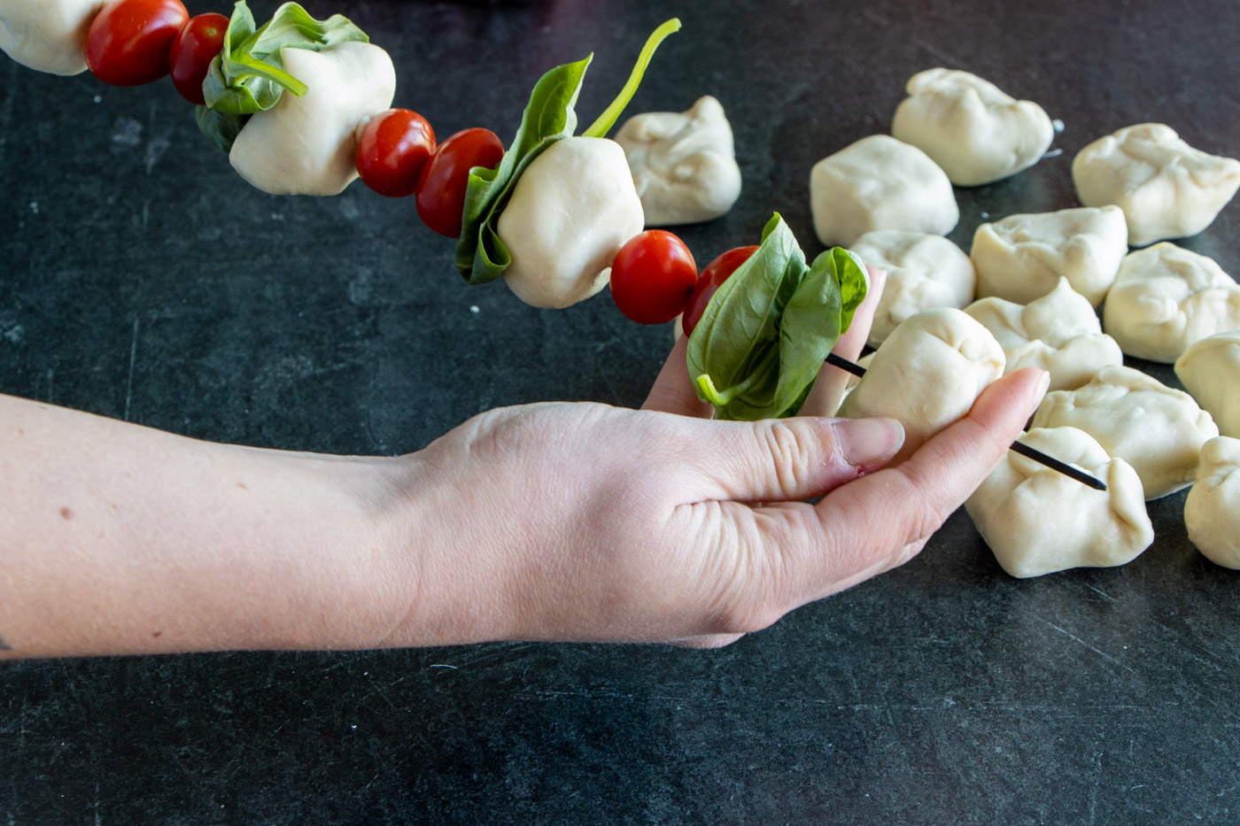 Caprese Skewers being assembled.