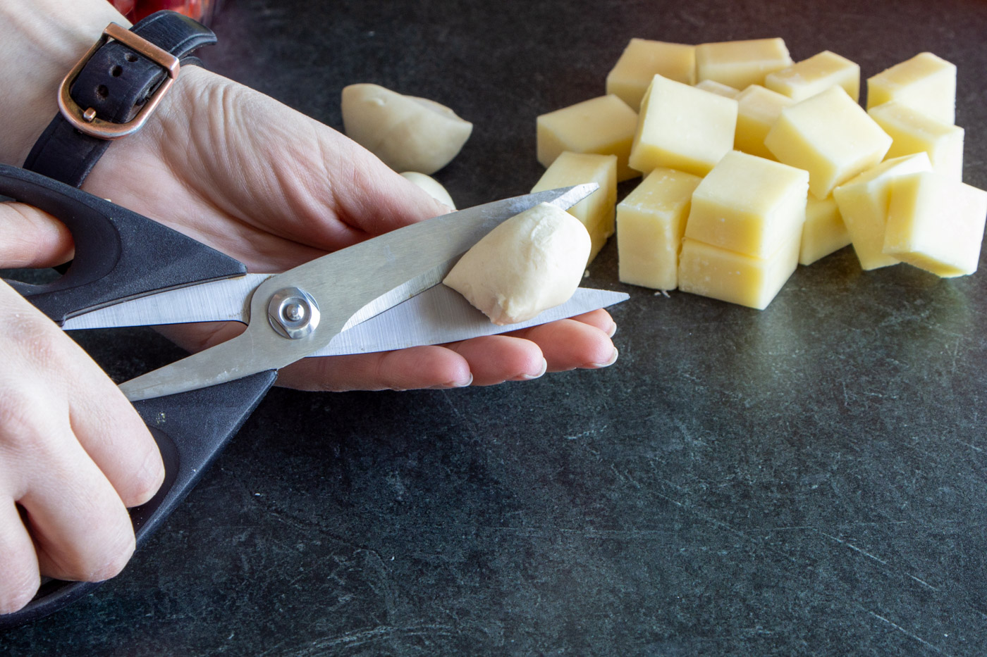 Cutting roll dough in half.