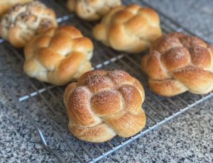 Braided rolls on top of a cooling rack.