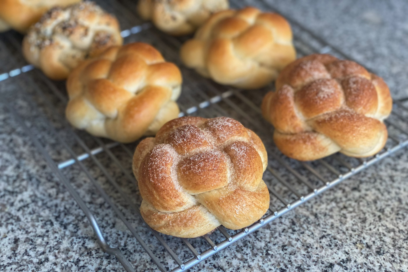 Braided rolls on top of a cooling rack.