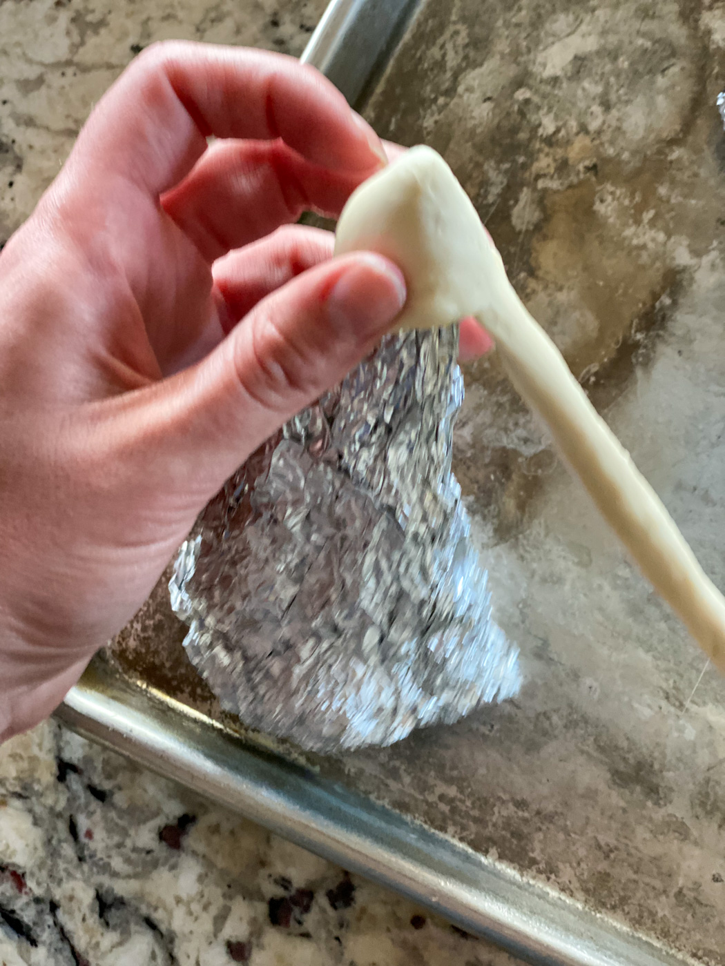 Wrap dough around aluminum cone.