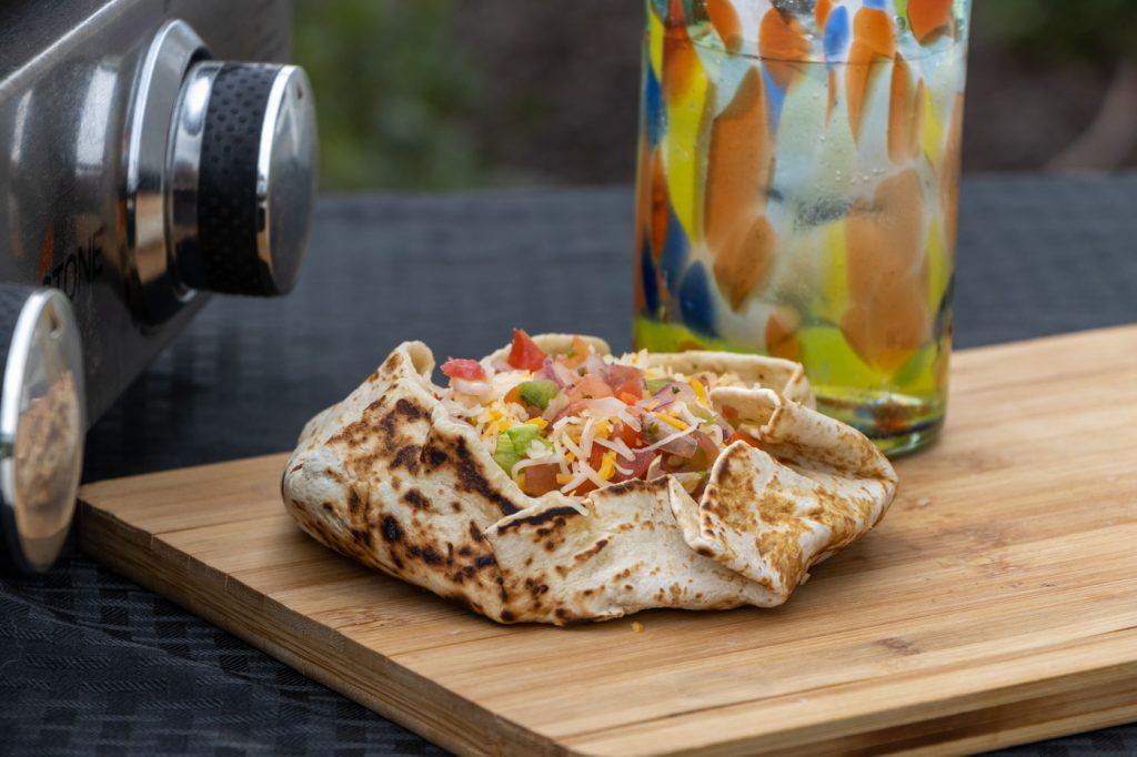 This taco wrap gets it's crunch from a tostada in the middle of delicious taco fillings; and of course wrapped up in a delicious Rhodes grilled flatbread.