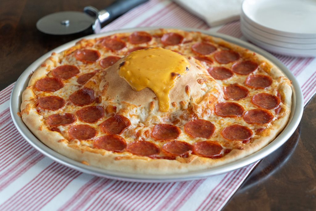 Everyone will be amazed by the molten cheese volcano that they can dip their slice into on this tasty pizza.